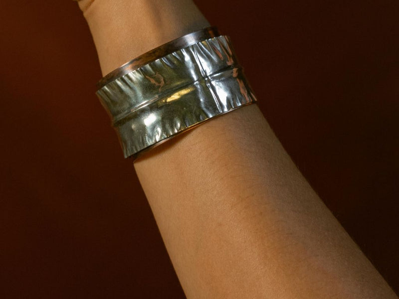 A model showing off a copper and Argentium Silver mixed metal cuff bracelet from Junebug Jewelry Designs