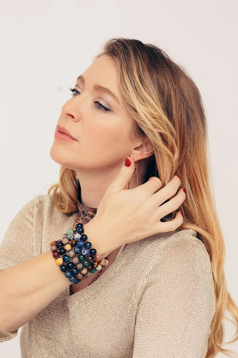 A model wearing a stack of Innerjee Collection semi precious gemstone beaded bracelets from Junebug Jewelry Designs