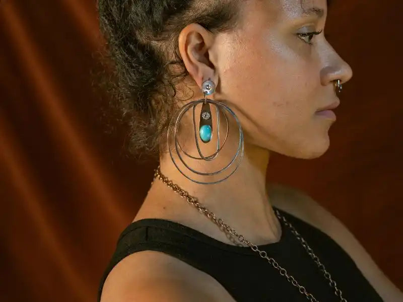 Large hoop earrings with turquoise stone and silver accents.