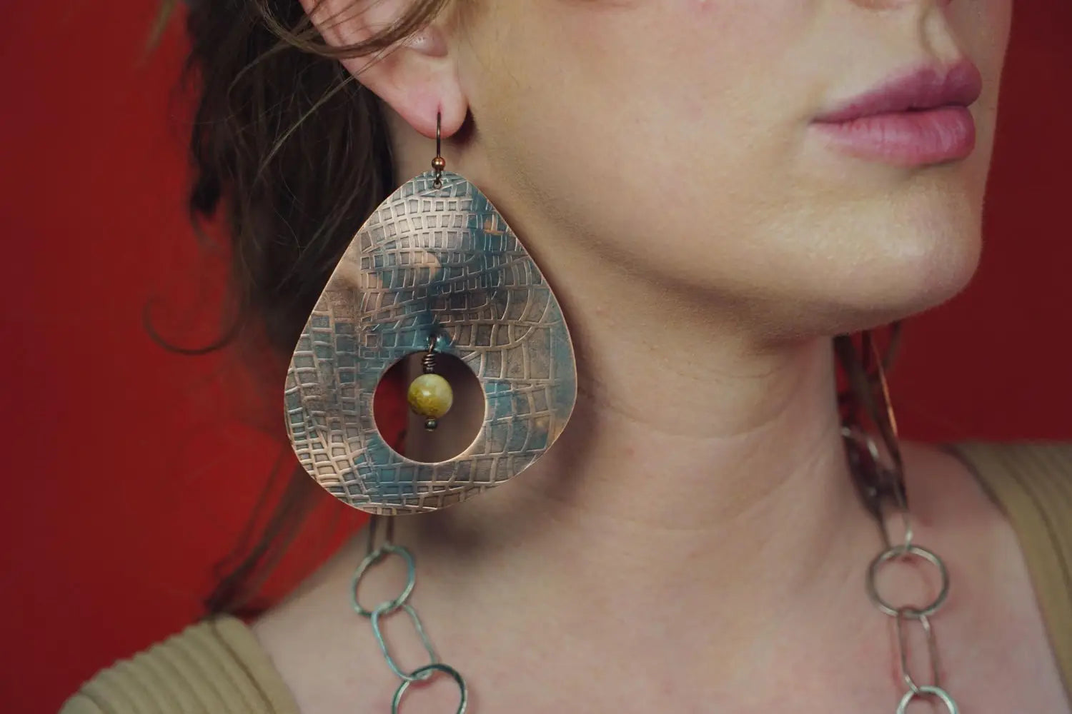 A model wearing Etched Copper Statement Earrings from Junebug Jewelry Designs