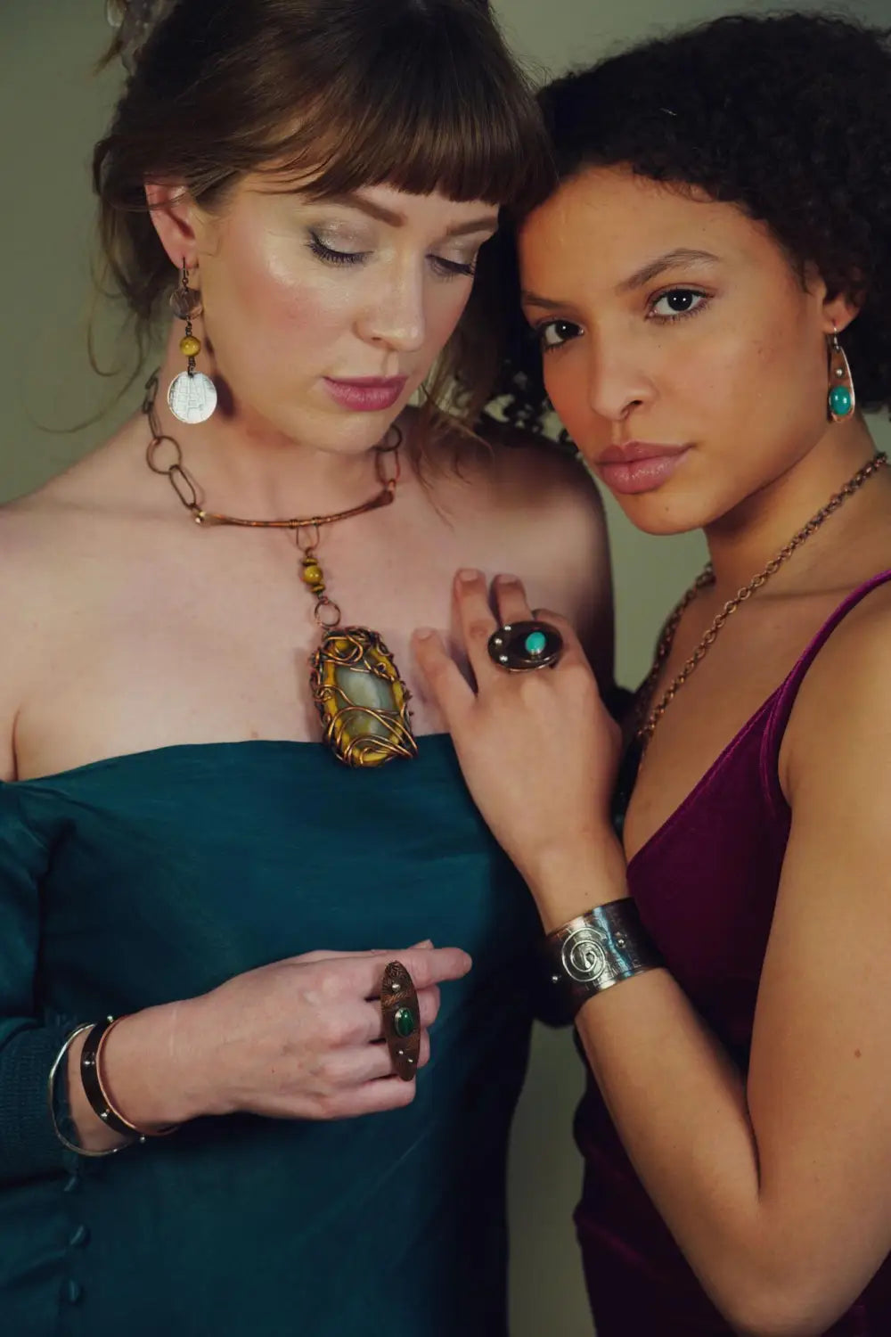 Two models wearing a variety of copper jewelry created by Junebug Jewelry Designs. Explore the many benefits of wearing copper.