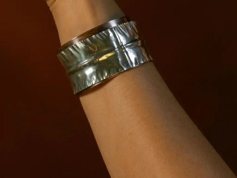 A model showing off a copper and Argentium Silver mixed metal cuff bracelet from Junebug Jewelry Designs