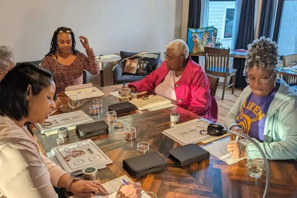 Woman choosing beads to use in her design at Junebug's Wine & Bead Party